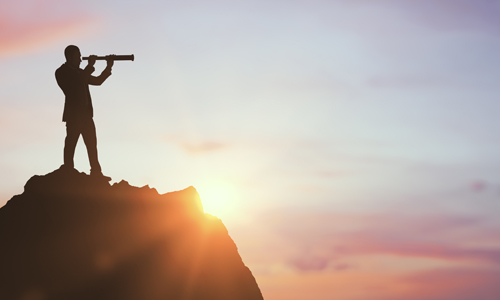 Man on mountain using binocular